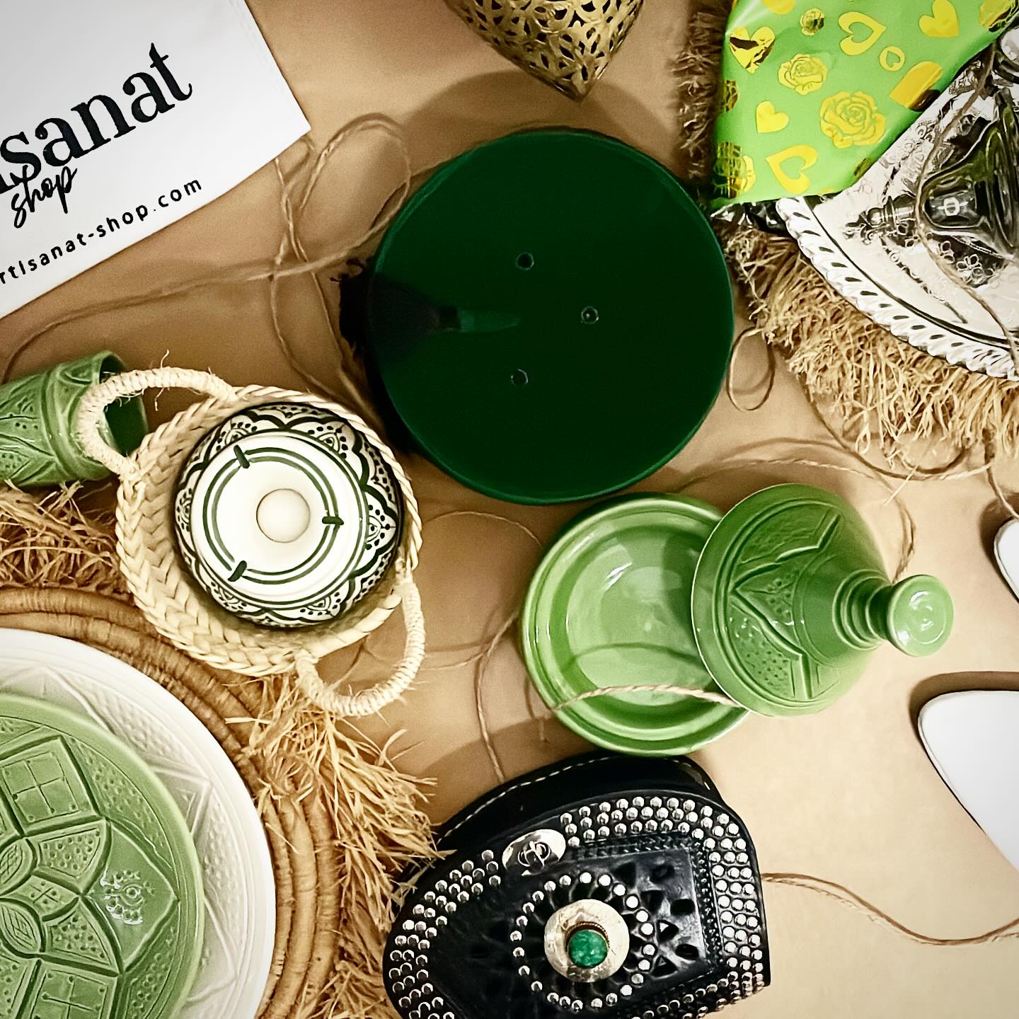 Overhead Artisanat Shop gift composition with green ceramics, silver tea service, basketry, and jewellery